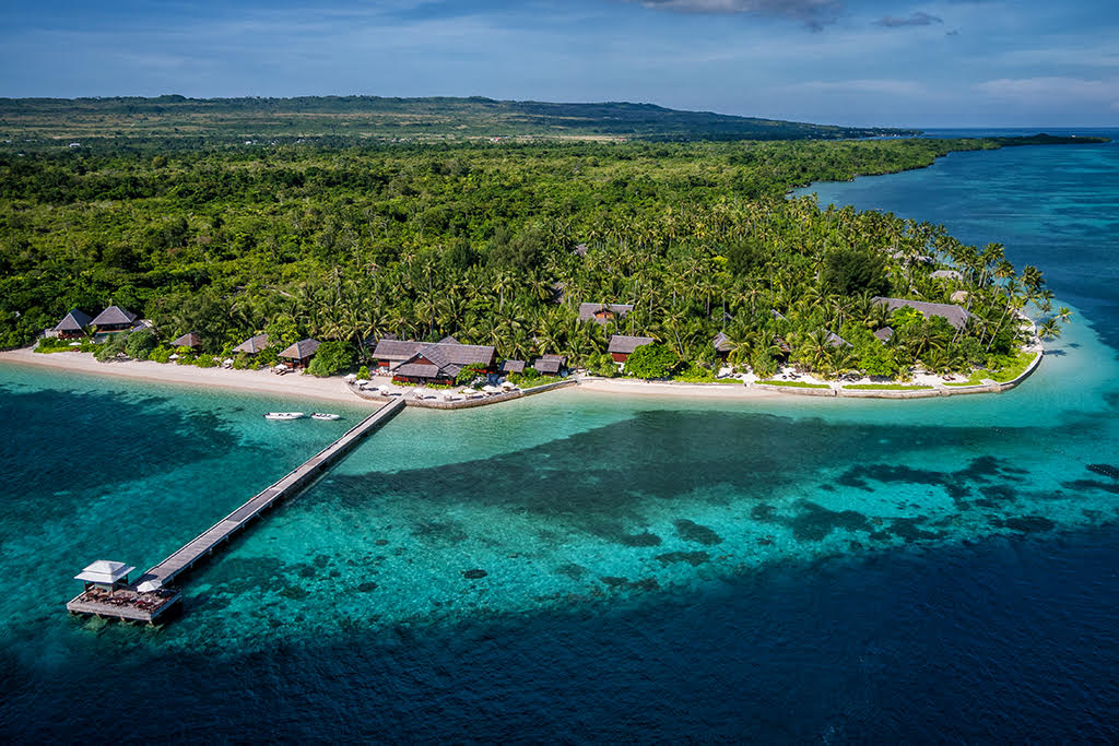 An aerial view of Wakatobi Resort reveals the dramatic coral formations of the House Reef. The Jetty Bar perches on the edge of this drop-off.