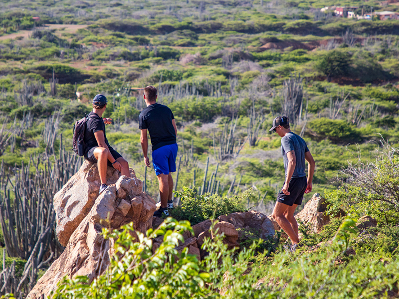 Hikers admire the view after climbing to a viewpoint on the hilly northern interior of Bonaire.