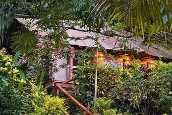 The Tented Bure at Sau Bay nestles into lush tropical landscaping.