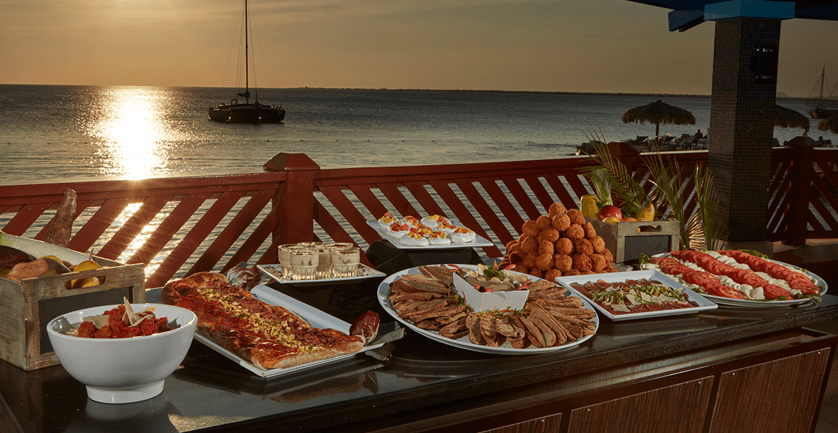 Waterfront dining with sunset views makes a stay at Divi Flamingo even more memorable.