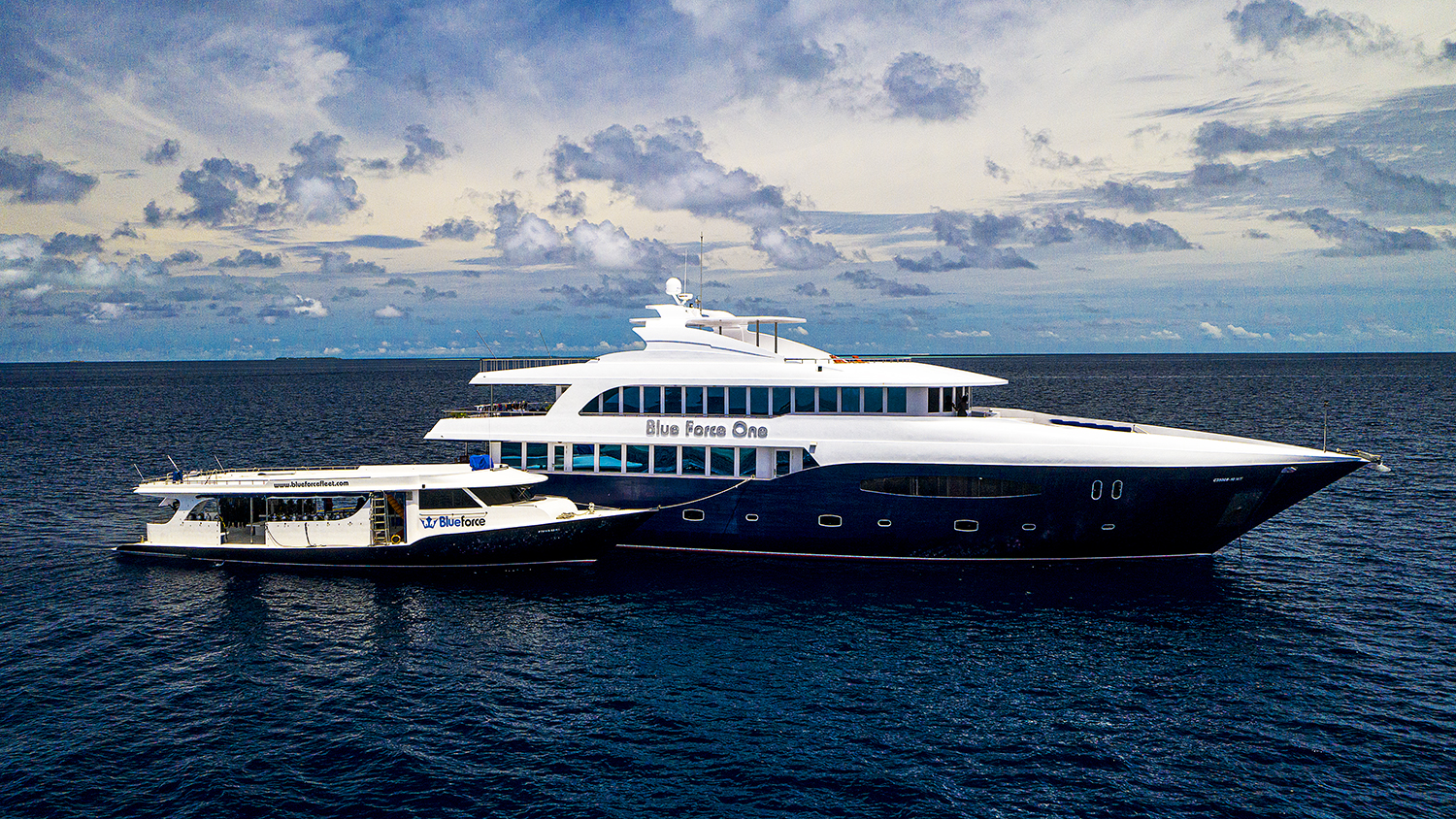 A Maldives liveaboard with it's attending dhoni moored alongside.