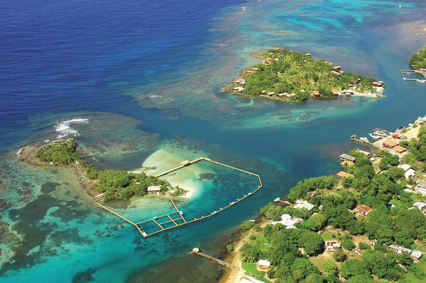 A birdseye view of the Anthony's Key Resort and its surrounding reefs, with Bailey's Key to the left, and the bungalows on Anthony's Key to the right. 
