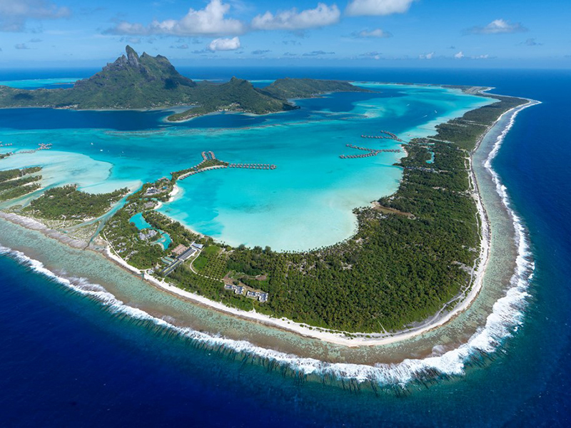 Tahitian lagoons created by fringing coral reefs become natural aquariums.