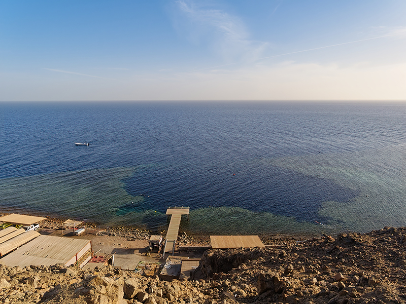The Dahab Blue Hole sits on the inner edge of a deep wall.