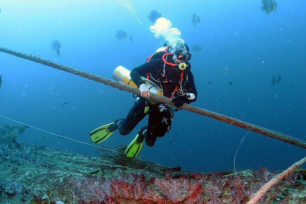 An extended-range diver pauses to survey the wreck of the HMS Repulse.